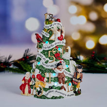 LED Christmas tree figurine, green base with red accents and small character figures