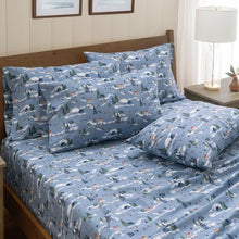 Blue printed cotton sheet set with winter scenes and layered pillows