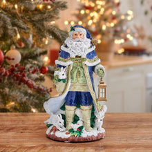 Santa figurine with blue coat, green trim, lantern, and small white rabbits at base