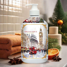 Holiday hand soap bottle with white pump and Orange Spice label over winter city scene