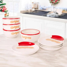 White Santa face bowls and plates with red rims arranged on countertop
