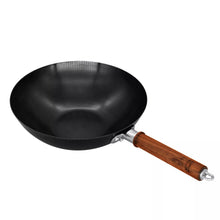 Carbon steel wok with dark wood handles and curved pouring rim