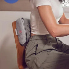 Gray contoured gel massage pillow positioned against the lower back with mesh panel