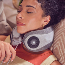Portable neck massager with gray fabric strap and black control pad, worn on neck