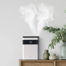 Ultrasonic humidifier releasing visible mist plume