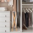 XL towel warmer placed in closet space on a wooden folding stand