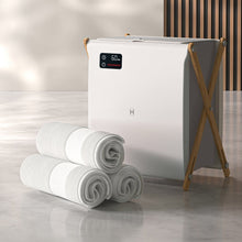 XL towel warmer with folded white towels, front control panel on wooden stand