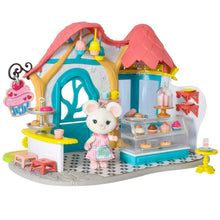 Miniature dollhouse bakery with cupcakes, tea set, and attached mouse figure