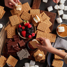 Assorted graham crackers with chocolate squares, berries, and marshmallow pieces