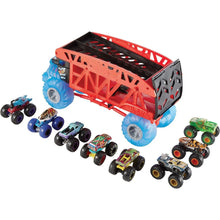 Red monster truck hauler with black bed, blue wheels, and mini trucks lined up