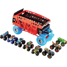 Red monster truck hauler with blue wheels plus several small monster trucks