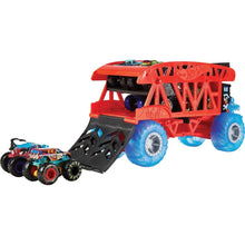 Red monster truck hauler with black ramp and blue wheels, plus a monster truck