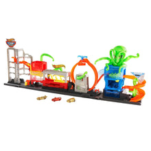 Toy car wash playset with green octopus figure, orange sprayers, and small cars