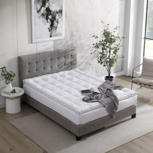 White quilted polyester-filled mattress topper on a bed surface