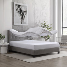 White polyester-filled mattress topper pad on a bed with a folded edge