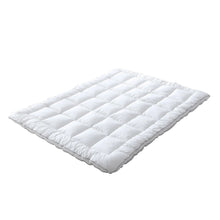White quilted polyester-filled mattress topper pad, flat and folded