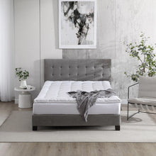 Polyester-filled mattress topper with white quilted baffles on a bed