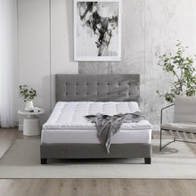 White quilted polyester mattress topper on bed with ties folded at corner