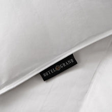 White comforter label tag reading HOTEL GRAND