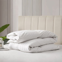 White down comforter neatly stacked with folded corners