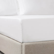 White sheet set corner with elastic gathers on the mattress and side drape