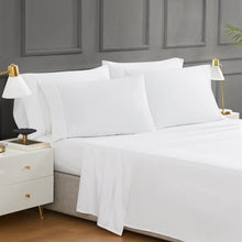 White 6-piece sheet set with multiple pillowcases and draped top sheet
