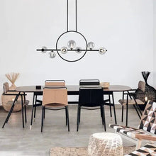 Circular black LED pendant light with clear glass bulbs and two hanging cords