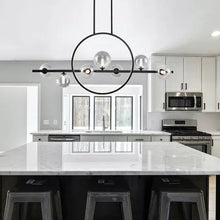 Circular black island pendant light with clear glass bulbs and black metal crossbar