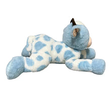 Blue and white cow plush lying down, side view with dark horns and blue spots