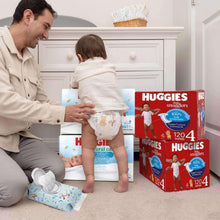 Huggies Natural Care baby wipes pack on the table with diapers nearby