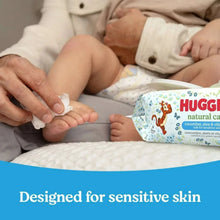 Baby wipes being dispensed with Huggies Natural Care wipes pack