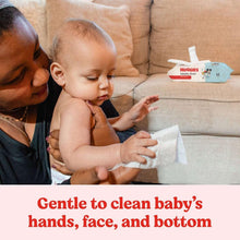 Baby and caregiver using wipes to clean baby’s hands, face, and bottom