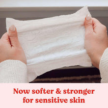 Opened white baby wipe held in hands for gentle cleaning