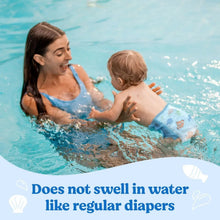 Blue Little Swimmers swim diaper on toddler in pool, ocean animal print