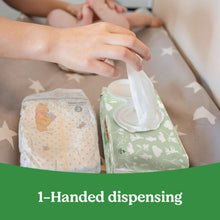 Hand wiping a baby with Huggies Natural Care sensitive baby wipes