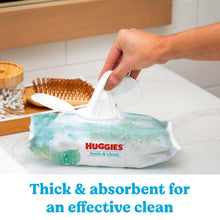 Hand lifting a wipe from a HUGGIES fresh & clean pack; thick absorbent wipes
