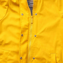 Yellow kids rain jacket close-up of center zipper and metal snap buttons