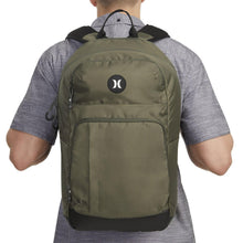 Olive rider backpack with front zip pocket and circular logo on upper panel.