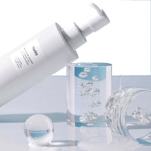 Huxley cleansing gel bottle pouring clear gel into small containers