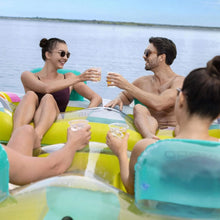 Inflatable party island with people lounging on colorful striped mesh deck