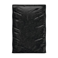 Square bag of dark mulch with crinkled plastic, filled with shredded material