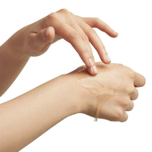Mugwort Essence applied to forearm by hand, visible glossy sheen on skin
