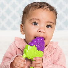 Infantino vibrating teether held by baby, showing purple and green shapes