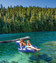 INTEX navy and white inflatable lounge floating on a lake with a person reclining