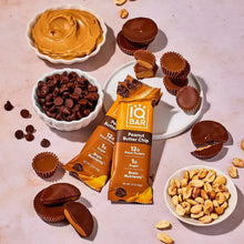 Plant protein bars with peanut butter spread, chocolate pieces, and peanuts