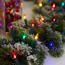 Lit multicolor mini glass LED lights on a Christmas tree