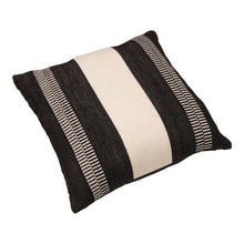 Decorative pillow with black and cream striped fabric, angled view