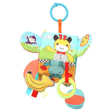 Plush activity cube with animal illustrations, banana and leaf textures, and hanging ring