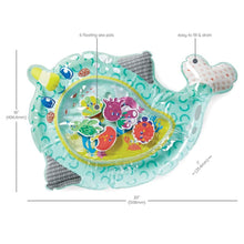 Narwhal-shaped teal play mat with inner oval window showing sea animals