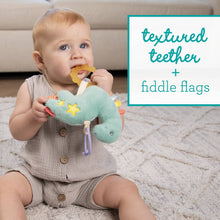 Teal plush dinosaur teether toy with star patches and dangling fiddle-flag textures.